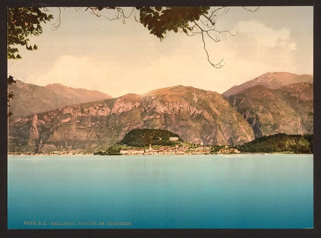 Varenna's pastel waterfront reflecting in the still waters of Lake Como at dawn