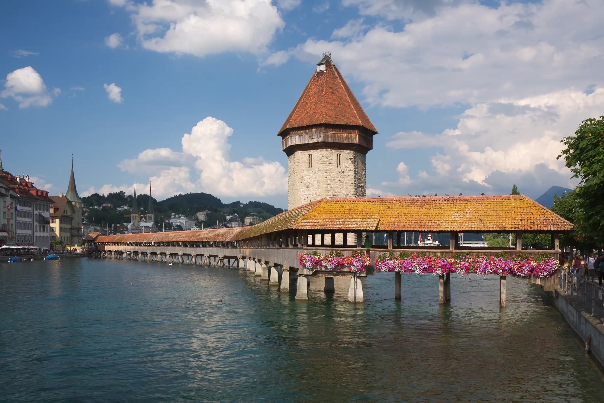 The Kapellbrücke and Water Tower at twilight, their reflections mirrored perfectly in the still waters of the Reuss River