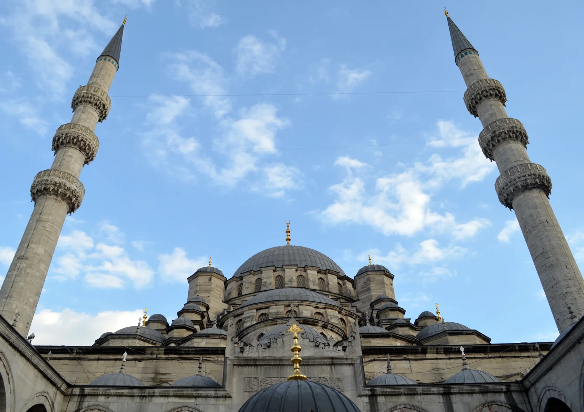 The approach to Istanbul from the Sea of Marmara at sunset — the Old City spread across seven hills, every dome and minaret gilded by the falling sun, the Bosphorus opening before you, the silhouette of the city shimmering like a mirage between Europe and Asia
