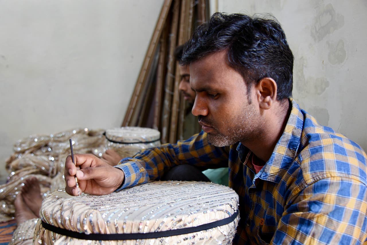 Artisan textile craftsmanship — intricate handwork detail