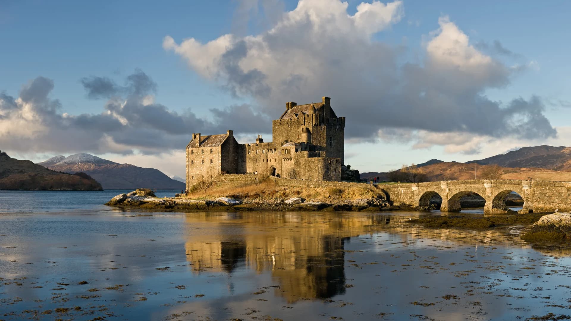 Eilean Donan Castle illuminated on the loch waters in the Scottish Highlands